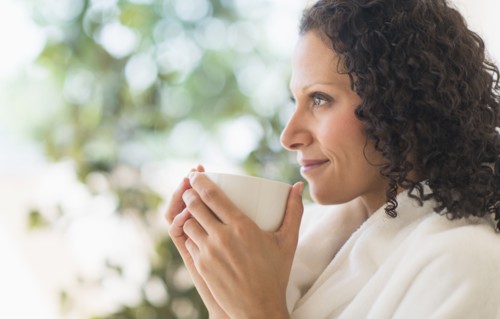 Woman relaxing with cup of coffee.