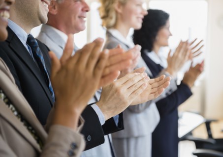 Office workers applauding. Photo: Jamie Grill