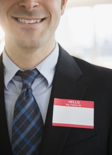 Office worker with name tag on suit. Photo : Jamie Grill