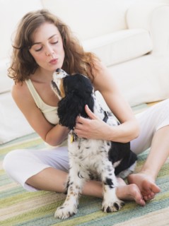 Portrait of young woman playing with dog. Photo: Daniel Grill