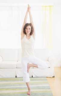 Young woman exercising at home. Photo: Daniel Grill
