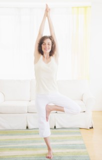 Young woman exercising at home. Photo: Daniel Grill