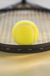Studio Shot of tennis racket with ball. Photo : Daniel Grill