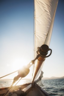 View of sea with yacht bow and sail in foreground. Photo : Daniel Grill