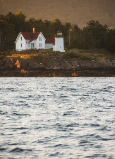 View of sea shore with small lighthouse. Photo: Daniel Grill