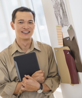 Mid adult fashion designer using digital tablet. Photo : Daniel Grill