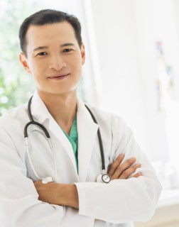 Portrait of happy mid adult doctor. Photo: Daniel Grill