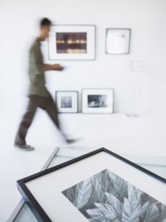 Preparations for new exhibitions in gallery with member of staff moving in background. Photo :