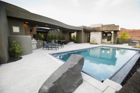 Modern luxury home facing swimming pool.