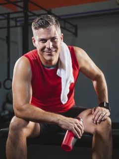Mature man taking break from exercising .