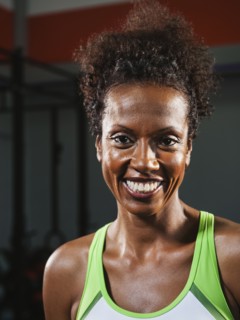 Portrait of happy mid adult woman wearing sports bra.