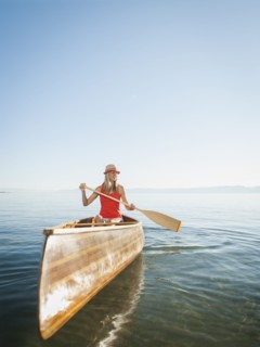 Portrait of young woman canoe traveling.