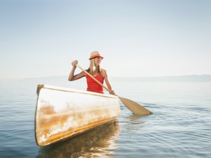 Portrait of young woman canoe traveling.