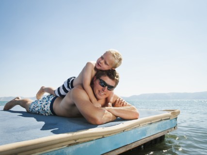 Father with son sunbathing.