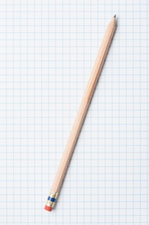 Single wooden sharpened pencil on graph paper. Photo : Kristin Duvall