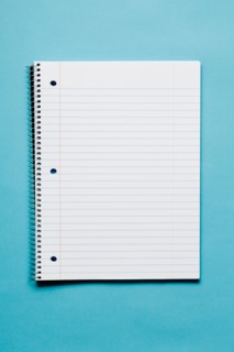 Blank spiral notebook on blue background. Photo: Kristin Duvall