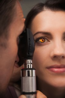 Close up of woman's eye lit up from doctor doing eye test. Photo : Mike Kemp