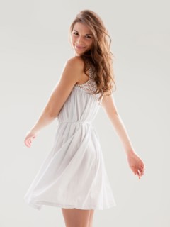 Beautiful woman swinging hips in summer dress. Photo : Mike Kemp