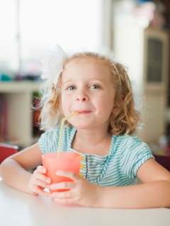 Portrait of girl drinking through straw. Photo : Jessica Peterson