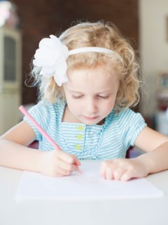Girl drawing with colour pencil. Photo: Jessica Peterson
