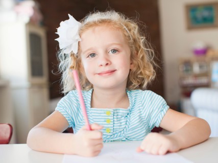 Girls portrait at table. Photo: Jessica Peterson
