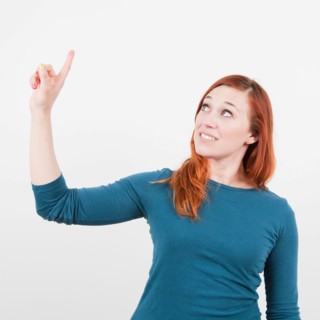Studio Shot, Portrait of woman pointing with finger. Photo: Jessica Peterson