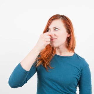 Studio shot, Portrait of woman holding her nose. Photo : Jessica Peterson