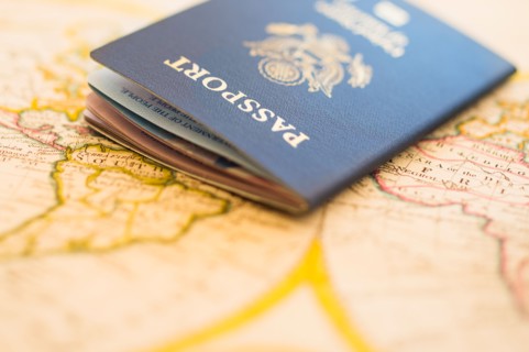 Passport sitting on antique map.