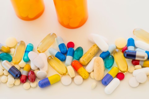 Colorful pills on white background.