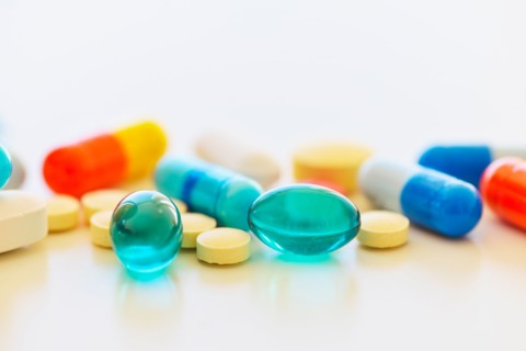 Colorful pills on white background.