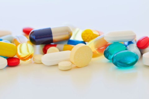 Colorful pills on white background.