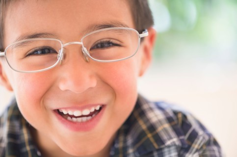 Portrait of boy (6-7) wearing glasses.