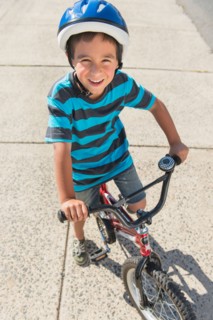 Portrait of boy (6-7) riding bicycle.