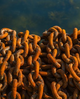 Rusty chains in harbor.