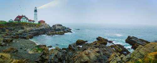 Remote coastline with lighthouse. Portland, Maine.