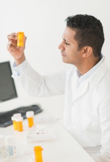 Pharmacist preparing prescription pills.