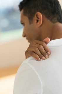 Man massaging his shoulder.