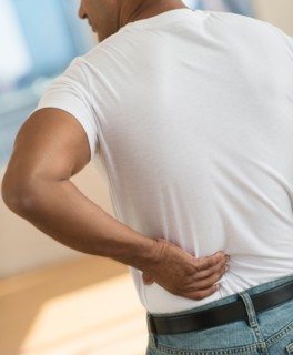 Man massaging his back.