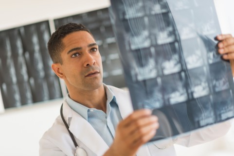 Male doctor reading MRI scan.