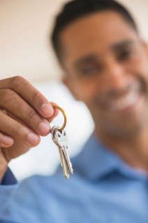 Close up of man's hand holding home key.