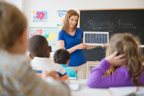 School children (8-9) with female teacher during class