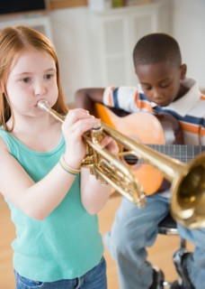 School children (8-9) with playing instruments during music class