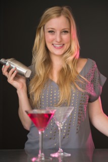 Young woman preparing martini