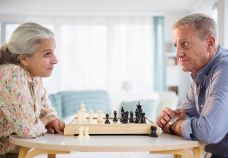 Elderly couple playing chess