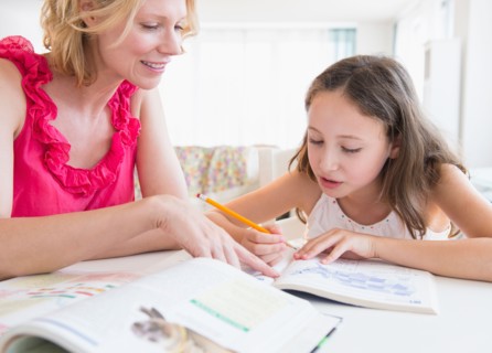 Mother and daughter (8-9 years) doing homework