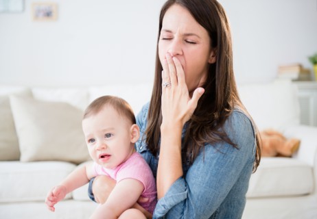 Mother with daughter (6-11 months) sitting in living room
