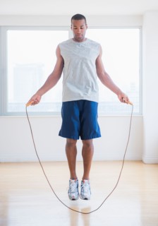 Young man skipping rope