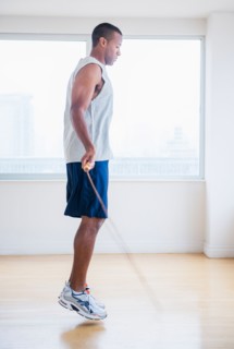 Young man skipping rope