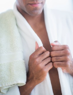 Young man in white bathrobe