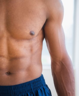Athletic young man showing abs